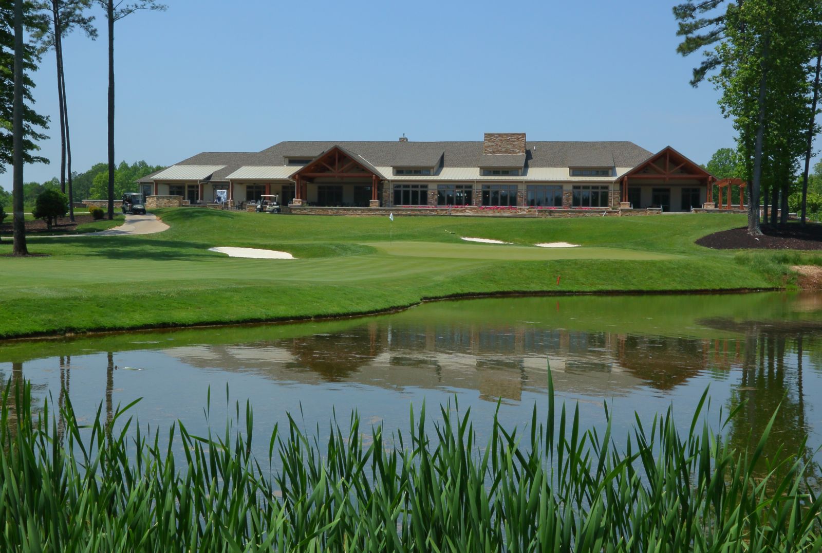view of clubhouse from behind a pond